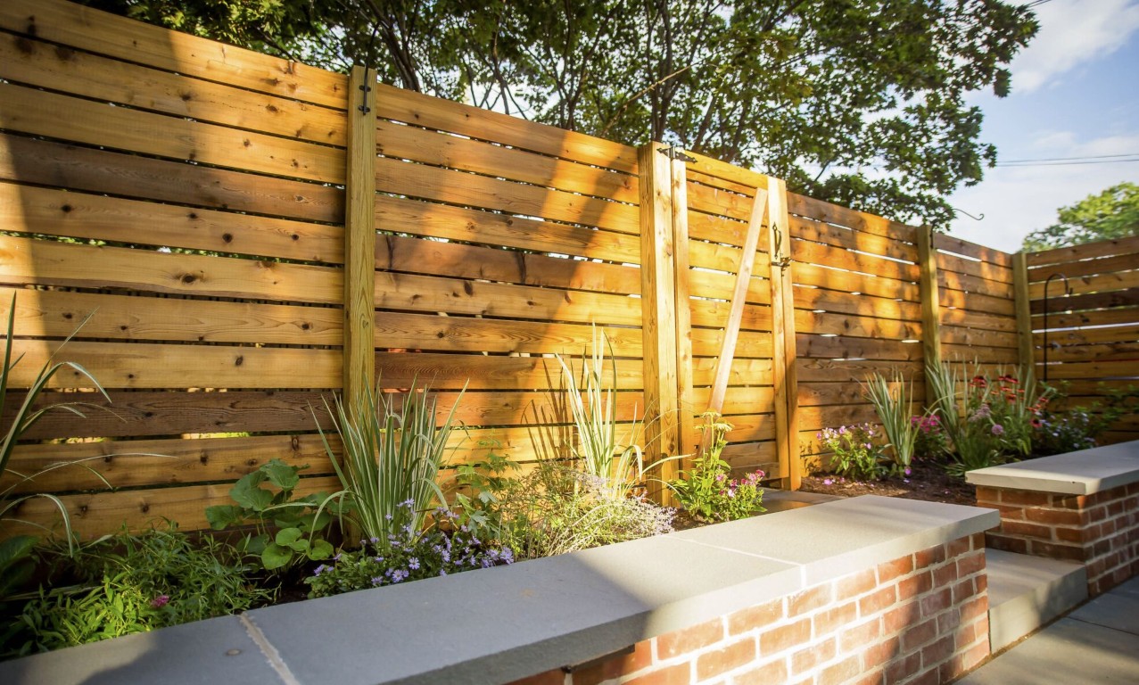 Custom wood fence installation in Ivins, UT with modern horizontal wood design with brick planters