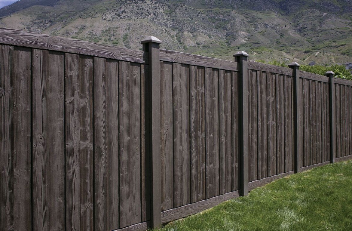 Commercial fence installation in Ivins, UT with dark stained vertical wood privacy design